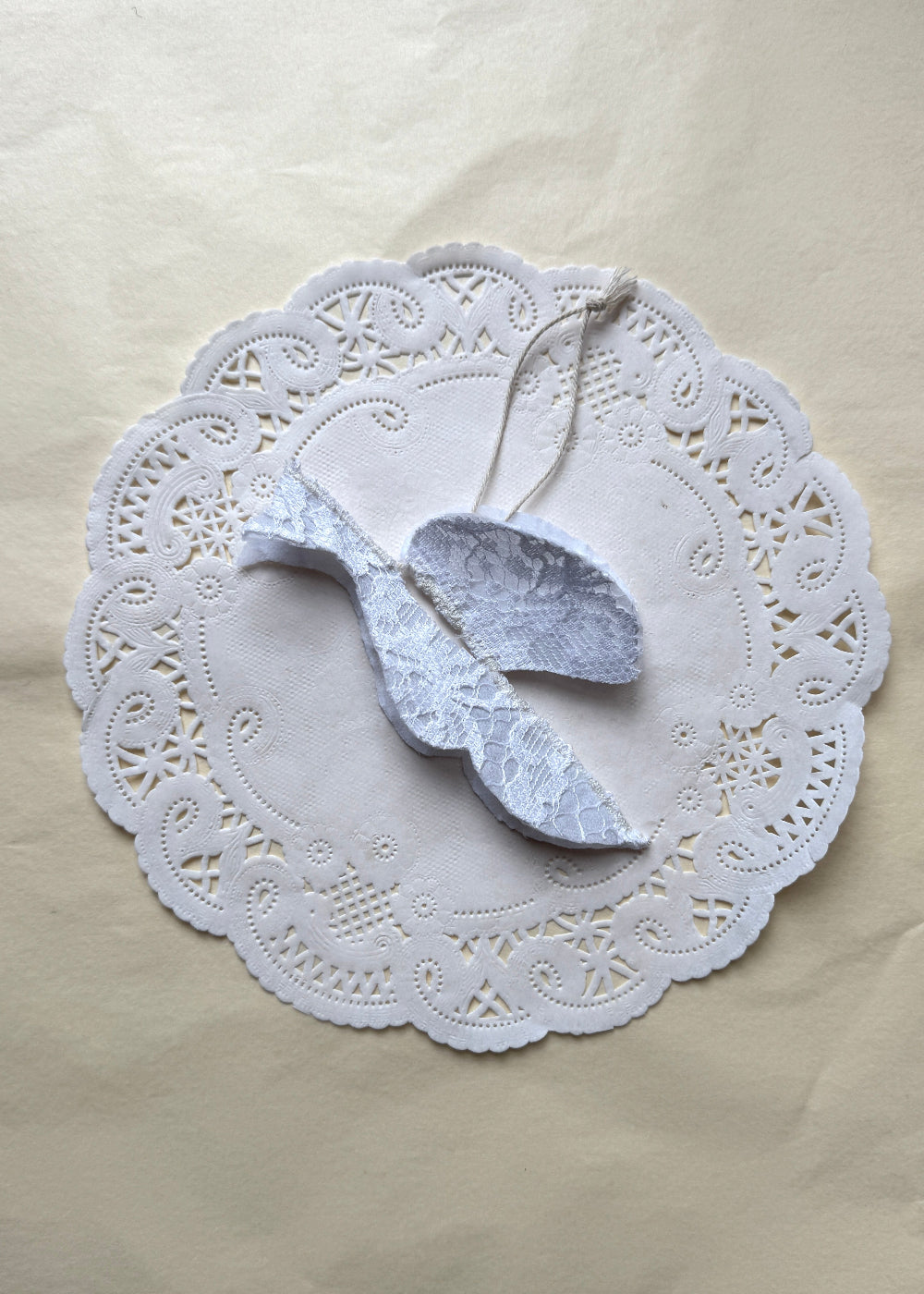 White lace Christmas bird in textile by AMANDA BUGGE studio with a strap
